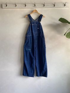 Amazing Vintage 50s/60s Lee Jelt Denim Dark Wash Overalls. Dark wash blue in color made from durable jelt denim (sanforized cotton) fibers. Button fly closure with a wide leg fit and adjustable shoulder straps. Condition overall is great with only minor flaws that include; a faded spot on front. There has been a small repair made on back as shown in photos. No rips, tears, or harsh staining. Please see all photos for details. Refer to measurements below to ensure a proper fit 38" waist 14" shoulder 26" inseam 56" in total length Dark Blue Overalls, Wide Leg Overalls, Blue Overalls, Des Moines, Cotton Fiber, Shoulder Straps, Favorite Outfit, Cool Outfits, Overalls