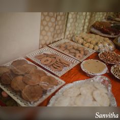 a table topped with lots of different types of food on top of plastic wrappers