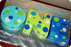 a cake that is shaped like the letter m and has polka dot designs on it