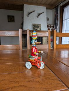 a wooden table topped with a toy motorcycle