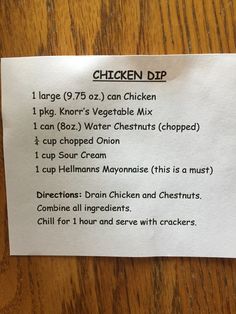 a piece of paper with instructions for chicken dip on it sitting on a wooden table