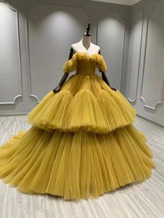 a yellow dress on display in a room