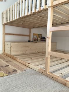 the bunk bed is made out of wood and has no mattresses on top of it