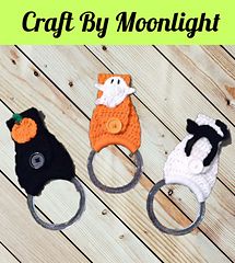 three crocheted animal key fobs are sitting on a wooden surface with the words craft by moonlight