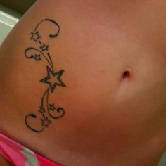 a woman's stomach with stars and swirls on it