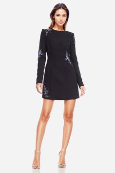 Catching feelings in The Camryn… Who doesn’t love a LBD with some sparkle? We certainly do. The Camryn is the definition of a perfect party dress. Whether you're attending a cocktail party, Thanksgiving, or even Hanukkah, this black mini dress will keep you cozy and feeling like the chicest woman in the room. Its shoulder pads and long sleeves create a polished look, and the embellishments scattered around elevate the dress to a luxurious level. The tulle underskirt adds a subtle throwback bell Long Sleeve Black Mini Dress, Catching Feelings, Black Long Sleeve Mini Dress, Cocktail Dress Wedding Guest, Tulle Underskirt, Sequin Wedding, Cocktail Dress Wedding, Cocktail Gowns, Flare Mini Dress