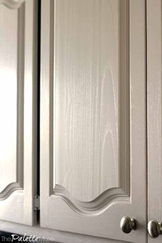 a close up view of the handles and drawers on a kitchen cabinet with white paint