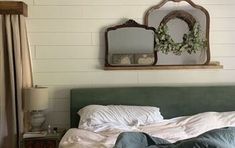 a man laying on top of a bed under a mirror