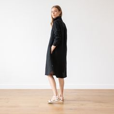 Washed Linen Shirt Dress in Black. Linen clothing for women in various colors. A Shape silhouette, long sleeves, knee length. Camilla With a fluid, drapey silhouette and long sleeves, our Camilla linendress is versatile, comfortable and effortlessly stylish. Thanks to the understated gathered detailing to the cuffs and back, delicate buttons and two handy pockets, this linen dress works as beautifully on a summer picnic as in the office. Available in Black, Graphite, Marine Blue, Sea Blue, Indig Black Long Sleeve Shirt Dress For Spring, Black Long Sleeve Shirt Dress For Winter, Black Long Sleeve Shirt Dress For Fall, Long Sleeve Shirt Dress For Fall, Long Sleeve Midi Dress For Daywear In Fall, Long Sleeve Midi Dress For Fall Daywear, Fall Long Sleeve Midi Dress For Daywear, Winter Knee-length Shirt Dress, Relaxed Fit Midi Dress For Fall