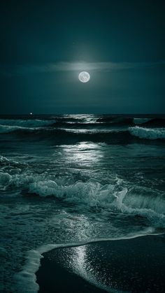 the moon is shining over the ocean waves