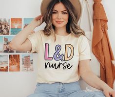 a woman wearing a t - shirt that says l & d nurse on the front