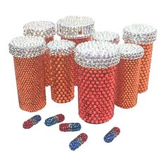 six red, white and blue plastic cups with pill caps