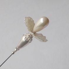 Pretty hatpin that I made using a mix of white faux pearls, silver colored findings, 1mm steel pin, hatpin is approx 6.5 inches long in total, comes with pin protector and will be sent in a gift box. Hat Pin, Stick Pins, Pearl Flower, Hat Pins, Faux Pearl, Beaded Jewelry, Accessories Hats, Perfume Bottles, Pearl Earrings