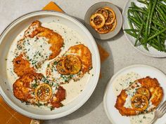 two plates of food on a table with green beans