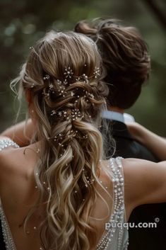 the back of a bride's head with her hair in a half - up braid