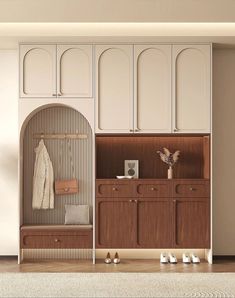 a white and brown room with some shoes on the floor next to a wooden cabinet