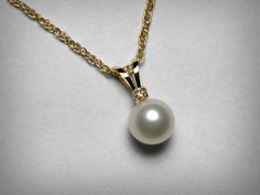 A dainty necklace or pendant, set with a natural freshwater pearl and a tiny genuine diamond. The pearl measures approximately 6.0mm in diameter, the diamond weighs .015 carats. The fine rope chain is also solid 14K yellow gold, 18 inches in length. Ideal as a gift for brides or the wedding party. Or for first communions and confirmations. Also available in 14K white gold. Ships in 1 to 2 business days. Ivory Pearl Necklace, Teardrop Bridal Earrings, Genuine Pearl Necklace, Single Pearl Necklace, Bridal Pearl Necklace, Single Pearl, Wedding Bridesmaid Jewelry, Pearl And Diamond Necklace, Pearl Necklace Wedding