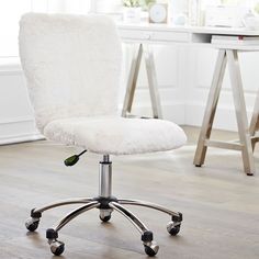 a white office chair with wheels in front of a desk