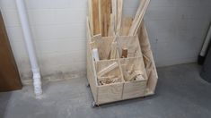 several pieces of wood are stacked up in a storage area next to a white brick wall