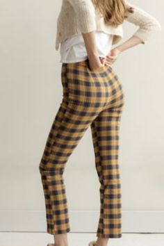 High-waisted pant from Urban Outfitters topped with an allover plaid finish. Notched at the hem and topped with a button closure at the zipper fly. Content + Care - 35% Polyester, 6% rayon, 5% spandex - Machine wash Casual Gingham Ankle-length Pants, Plaid Ankle-length Pants For Spring, Spring Plaid Ankle-length Pants, Casual Plaid Bottoms With Elastic Waistband, Chic Plaid Straight Leg Bottoms, Chic Plaid Bottoms For Business Casual, Casual Plaid Bottoms For Spring, Casual Plaid Bottoms For Fall, Plaid Straight Leg Pants For Fall