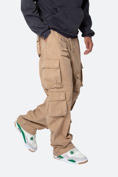 the Baggy Cargo Pants are designed with a baggy fit throughout with cargo pockets of different sizes throughout, zipper fly, and finished off with a vintage wash for improved hand feel and draping. details baggy fit 100% cotton  model is 6’1, 160 lbs and wears a size 30 Baggy Cargo Pants Aesthetic, Mens Baggy Cargo Pants, Khaki Cargo Sweatpants, Santi Aesthetic, Khaki Cargo Pants Outfit Men, Baggy Cargo Pants Outfit Men, Baggy Clothes Aesthetic Men, Tan Baggy Pants, Brown Baggy Cargo Pants