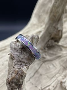 This beautiful handcrafted Stainless Steel comfort band is a real conversation starter! It features a Lavender Opal inlay in the center of the ring. The crushed Opal is placed by hand, incased in resin, and then finished and polished to a brilliant shine. Each ring I make is truly unique and no two are ever the same. These rings are made to order and are available in several sizes. Please allow 3-5 days for me to complete your ring. I do custom orders and if you have a different ring material or Opal Inlay Ring Gift, Opal Ring With Inlay Perfect For Gifts, Gift Opal Inlay Ring, Unique Opal Ring With Inlay For Gift, Oval Opal Ring With Inlay For Gift, Silver Opal Ring With Inlay For Gift, Adjustable Thick Band For Gift, Adjustable Thick Band Gift Bands, Diy Resin Ring