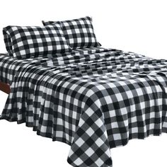 a black and white checkered bedspread with two pillow cases on each side