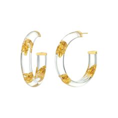 DISCO FEVER WHAT IT IS: Chic lucite hoops with one-of-a-kind gold-leaf patterns WHY IT’S SPECIAL: Glam and disco-ready, they put the 70s trend for lucite hoops back on the fashion map Gold leaf inclusions give every earring an element of uniqueness This playfully adorned lucite style can’t pass unnoticed GOOD TO KNOW: Handcrafted Lucite14K Gold Vermeil24K Gold LeafSize: 2" Due to their handmade nature, each piece is unique WHY WE LOVE GOLD AND HONEY: These four sisters bridge the gap between fas Gold Leaf Jewelry, Gold Leaf Earrings, Classic Earrings, Statement Earring, Leaf Jewelry, Leaf Earrings, Silver Leaf, Gold Plated Sterling Silver, Gold Leaf