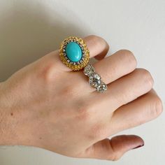 From our estate & antique collection, this vintage cocktail ring features an oval cabochon turquoise center surrounded by diamonds set in an 18K yellow gold high dome mounting with an engraved texture. Ring Size: 5.5 This is a special piece of jewelry from our estate collection. We hope you will enjoy the character and imperfections that are associated with a vintage item. Vintage Gold Turquoise Ring For Formal Occasions, Vintage Gold Turquoise Ring For Formal Events, Gold Vintage Turquoise Ring For Formal Occasions, Gold Vintage Turquoise Ring For Formal Events, Elegant Gold Turquoise Cabochon Ring, Elegant Turquoise Cabochon Diamond Ring, Elegant Gold Turquoise Ring For Formal Occasions, Vintage Yellow Gold Turquoise Oval Ring, Vintage Yellow Gold Oval Turquoise Ring