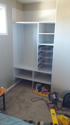 an empty room with shelves and tools on the floor