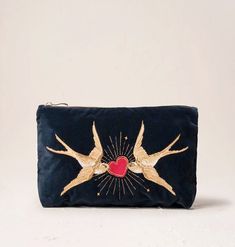 Our Swallow motif takes on a romantic new meaning, embroidered on a sumptuous velvet base with golden threads. This design carries messages of love, light and harmony, making it the perfect gift for those that mean the most. Designed to make your life a little more organised and a lot more luxurious, this timeless Everyday Pouch features delicate embroidery on soft, durable bases. Ideally sized, it is perfect for storing your daily essentials, fitting in your handbag, or using as a clutch. Mater Travel Beauty Bag, Elizabeth Scarlett, Heart Coin, Face Kit, Beating Heart, Love Light, Sneaker Jewelry, Nature Inspired Jewelry, Day Bag