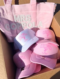 pink and white hats in a box with the words mrs copolia on it