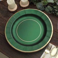 a green plate sitting on top of a wooden table next to a fork and knife