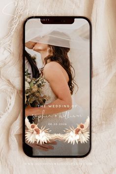 an iphone case with a wedding photo on the screen and flowers in front of it