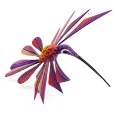 a purple flower with long black stems on it's head is shown against a white background