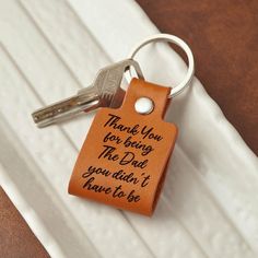 a leather keychain with the words thank you for being the dad you didn't have to be