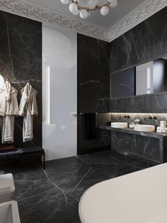 a black and white bathroom with marble walls