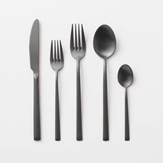 five forks, two spoons and one knife on a white surface