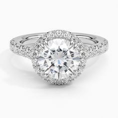 a white gold engagement ring with an oval center surrounded by round brilliant cut diamonds