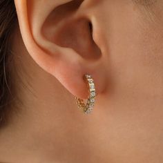 Introducing the 14k Gold Surface Prong Setting Hoop Earrings, the ultimate accessory for any fashion-savvy woman. These stunning earrings are crafted from high-quality 14k gold and feature a beautiful full eternity of sparkling CZ gemstones, making them the perfect addition to any outfit. Whether you're dressing up for a special occasion or simply looking to add a touch of elegance to your everyday wardrobe, these earrings are sure to make you feel confident and stylish. The huggie design of the Gift Round Hoop Earrings With Sparkling Stones, Anniversary Huggie Earrings With Sparkling Stones, Cubic Zirconia Huggie Earrings With Sparkling Stones For Anniversary, Anniversary Cubic Zirconia Huggie Earrings With Sparkling Stones, Anniversary Gift Cubic Zirconia Huggie Earrings With Sparkling Stones, Anniversary Huggie Earrings With Sparkling Cubic Zirconia, Fine Jewelry Hoop Earrings With Sparkling Stones For Anniversary, Diamond White Hoop Earrings With Prong Setting As Gift, Gift Diamond White Hoop Earrings With Prong Setting