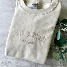 Tan Embroidered Sweatshirt, Tone On Tone Sweatshirt, Trendy Embroidered Sweatshirt, Cream Embroidered Crew Neck Sweatshirt, Cream Crew Neck Sweatshirt With Letter Embroidery, Relaxed Fit Embroidered Cream Sweatshirt, Cream Embroidered Relaxed Fit Sweatshirt, Casual Short Sleeve Sweatshirt With Custom Embroidery, Crew Neck Top With Embroidered Text For College