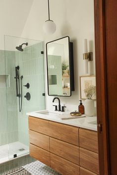 a bathroom with a sink, mirror and shower