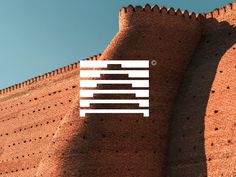 the logo for ibm is displayed on an old brick wall in front of a blue sky