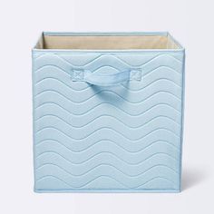 a blue storage box with a bow on the front and bottom, sitting against a white background