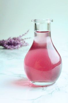 a pink vase sitting on top of a white counter