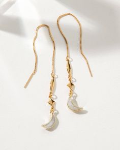 These earrings feature delicate 3.5" chains with weightless gemstone crescents that sway elegantly. Perfect for those who love a hint of whimsy, they glide on effortlessly, their movement reminiscent of a moonbeam's dance. Captivate your clientele with this fusion of Italian-inspired design and modern minimalism. Style details: Genuine Moonstone 14KT Gold Plated Brass Threader length: approx. 3.5” Earring Box Elegant Half Moon Metal Jewelry, Elegant Half Moon Metal Earrings, Elegant Crescent Moonstone Jewelry, Elegant Jewelry With Adjustable Chain And Moon Shape, Elegant Jewelry With Moon Shape And Adjustable Chain, Elegant Moon Shaped Jewelry With Adjustable Chain, Elegant Moon-shaped Jewelry With Adjustable Chain, Elegant Moon Shaped Metal Earrings, Elegant Moon-shaped Metal Earrings