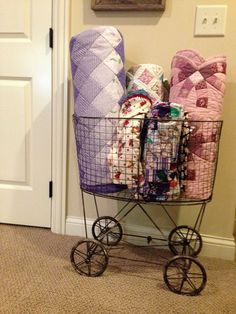 a basket filled with blankets sitting next to a door