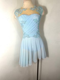 a light blue dress on a mannequin with sequins and beading