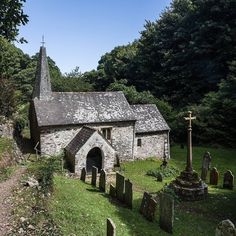 an old stone church surrounded by graves and trees