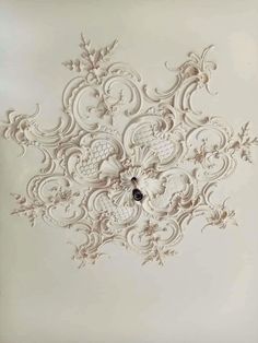 an intricately designed ceiling with white paint